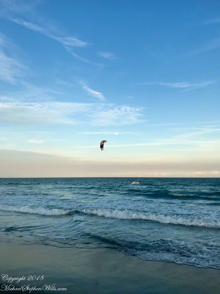 Risen Full Moon and Surf Boarder at Sunset