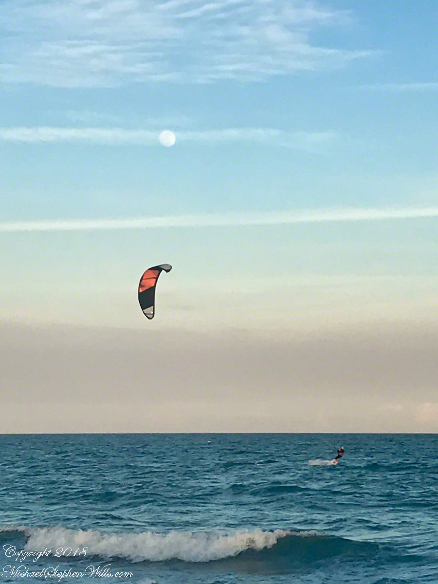 Risen Full Moon and Surf Boarder at Sunset